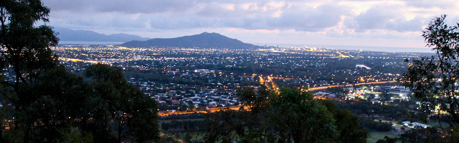 Skyline over the city showcasing the night scene and natural landscape surrounding the city